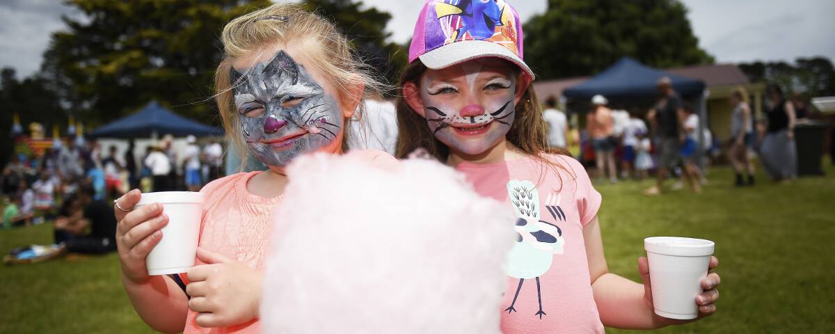 PARTY: Amarli Purtell, aged five, and Makayla Lendrec-Doggett, six, get into the Christmas festive spirit with free fairy floss, face painting and rides. Picture: Luka Kauzlaric
