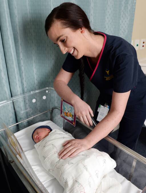 CARING: Ballarat Health Services' midwife Tess Pollard spends time checking on almost one-day-old Louie Tucker Martin on Wednesday afternoon. Picture: Kate Healy