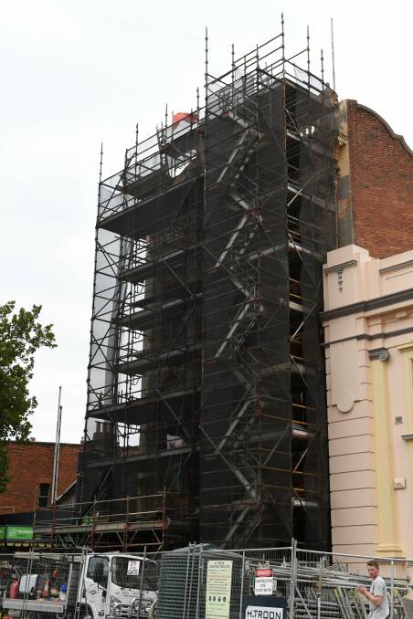 RESTORATION MASK: Paint-stripping works underway on Ballarat Trades Hall's exterior this week. Picture: Lachlan Bence