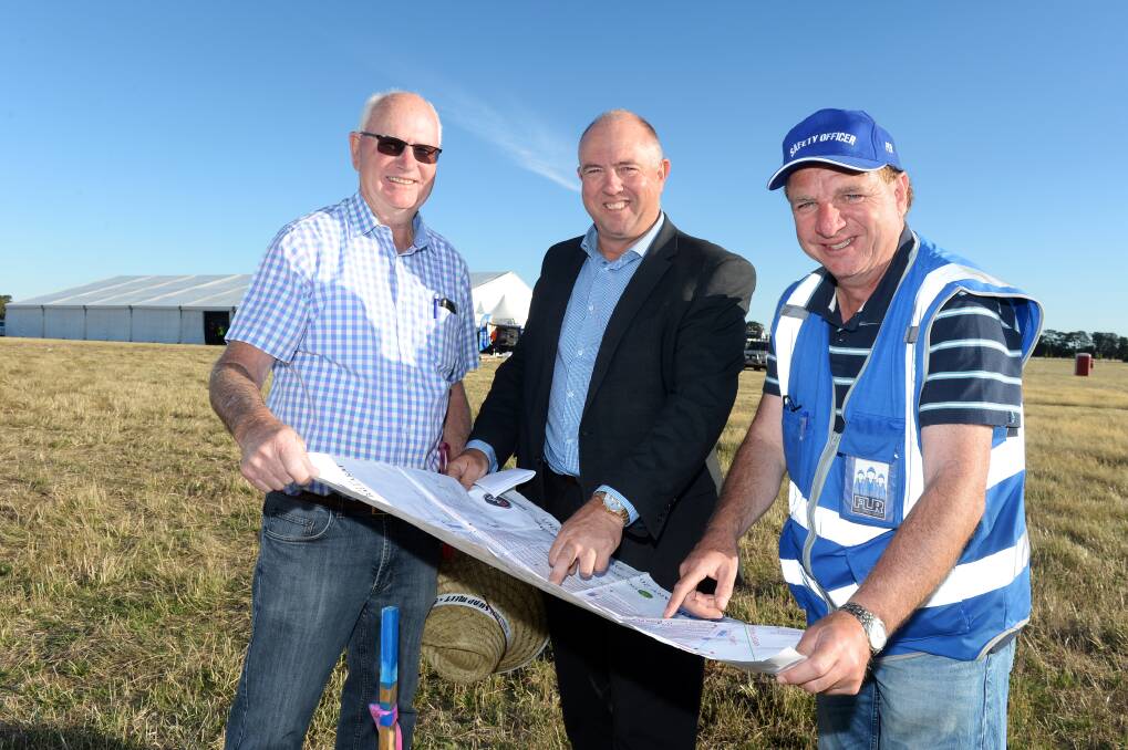 FINAL CHECK: Rotarians Lindsay Florence, Darren Trigg and Frank Cotronea check off the map to ensure physical construction is complete for trading to start at Ballarat Swap Meet on Thursday night. Picture: Kate Healy