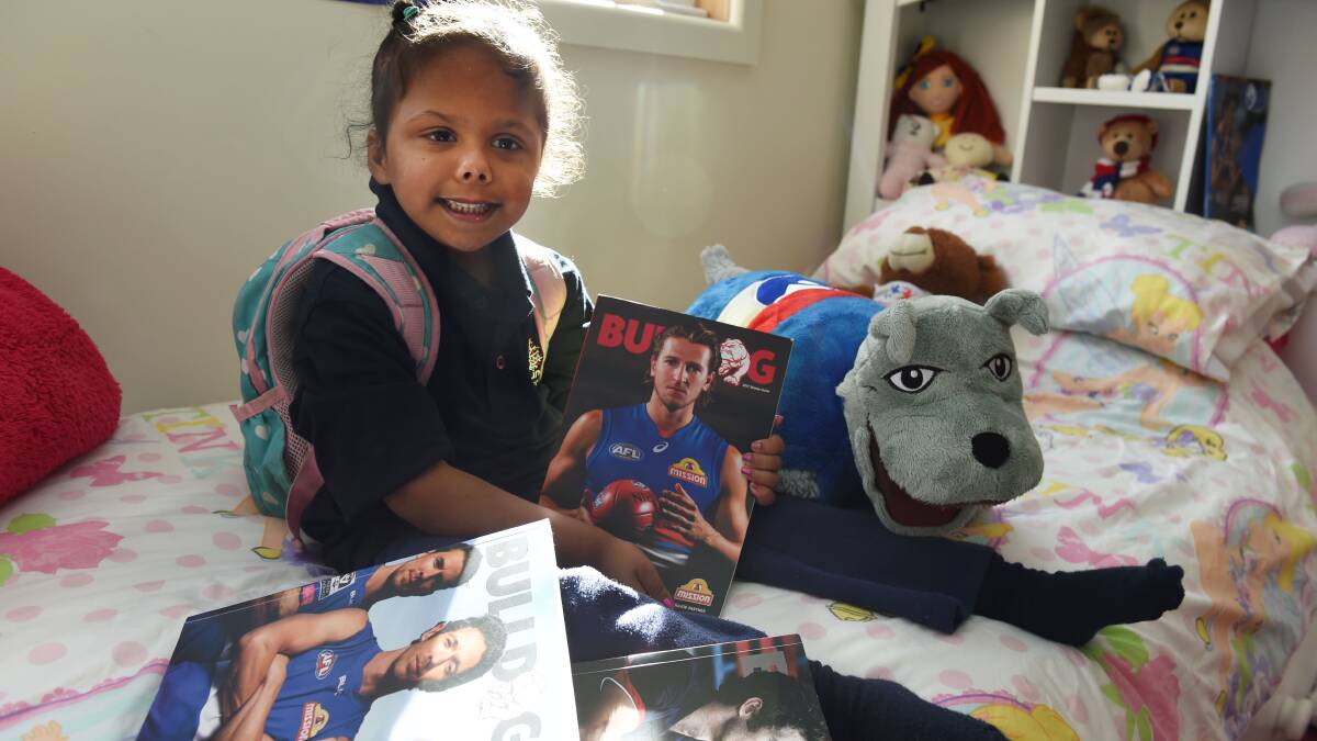 Alira with pictures of her favourite Western Bulldogs' player Marcus Bontempelli. Picture: Lachlan Bence