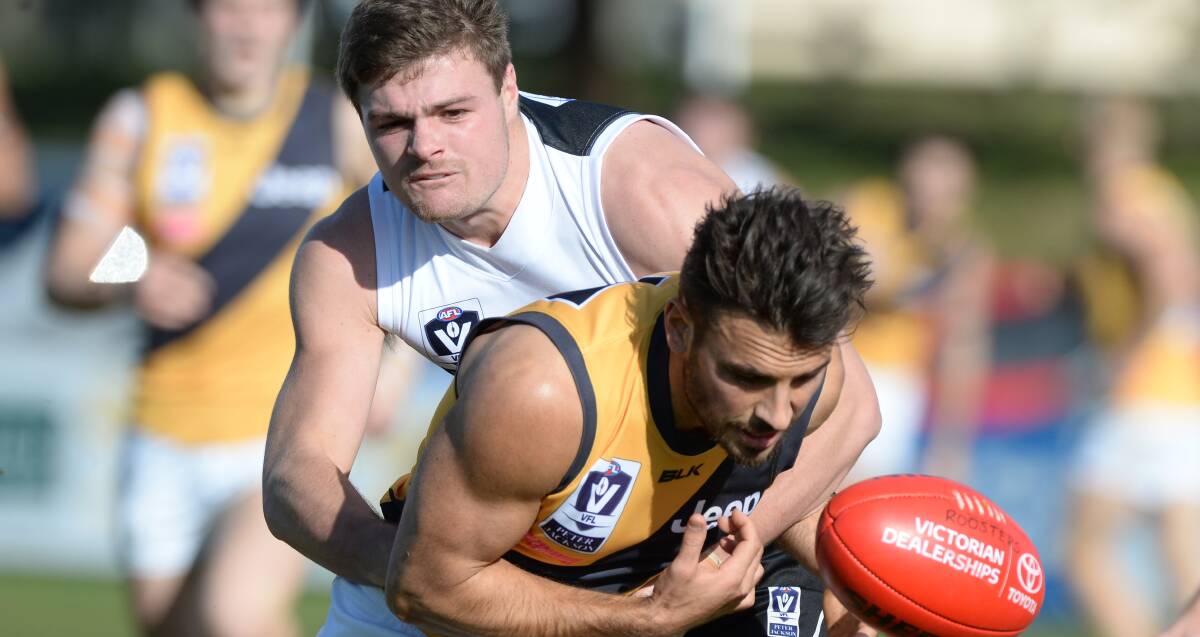 ALWAYS LEARNING: Roosters youngster Sam Scott takes on in-form AFL-listed Tiger Sam Lloyd (Richmond) in VFL action at Eureka Stadium on Sunday. Picture: Kate Healy