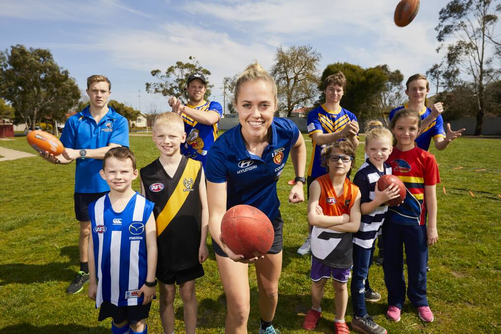 SET: Kaitlyn Ashmore with nephew Ollie and fans from AFL preliminary final contenders  Elijah (Richmond), Archie (GWS), Ella (Geelong) and Imogen (Adelaide).