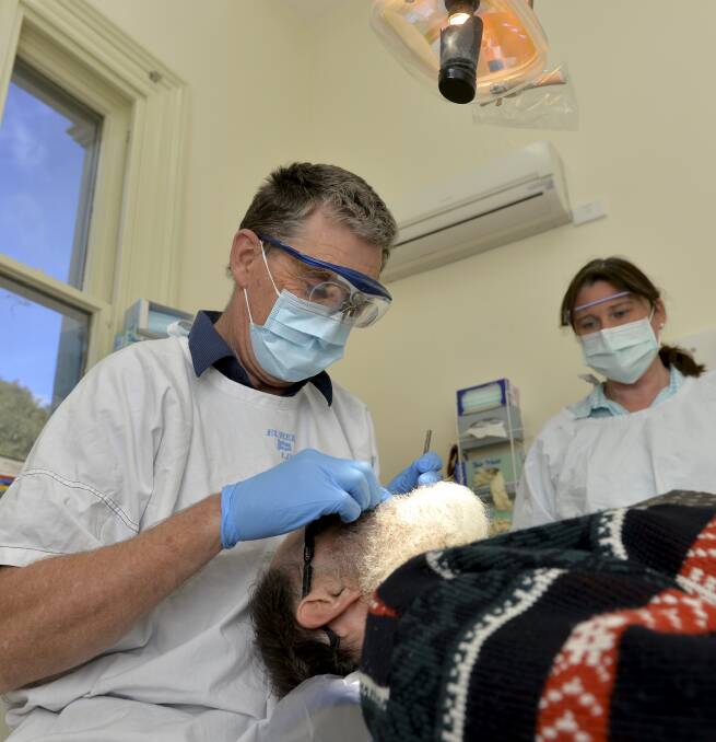 POLISH OFF: Hepburn Health Service dentish Linden Hall starts a routine clean for a patient in Daylesford on Friday. Experts say regular check-ups with routine brushing and a good diet promote dental health. Picture: Dylan Burns