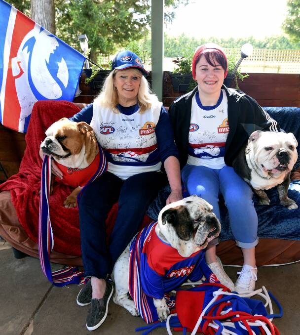 BULLDOG FAMILY: Tanya Templeton and daughter Macy with a couple of members of their Bulldog pack wear their colours proud for AFL grand final day. Picture: Lachlan Bence