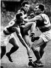 LOCKDOWN: Alan Martin (left) and Footscray teammate Harvey Stevens put tight pressure on Geelong rover Peter Pianto in a semi-final at the MCG.