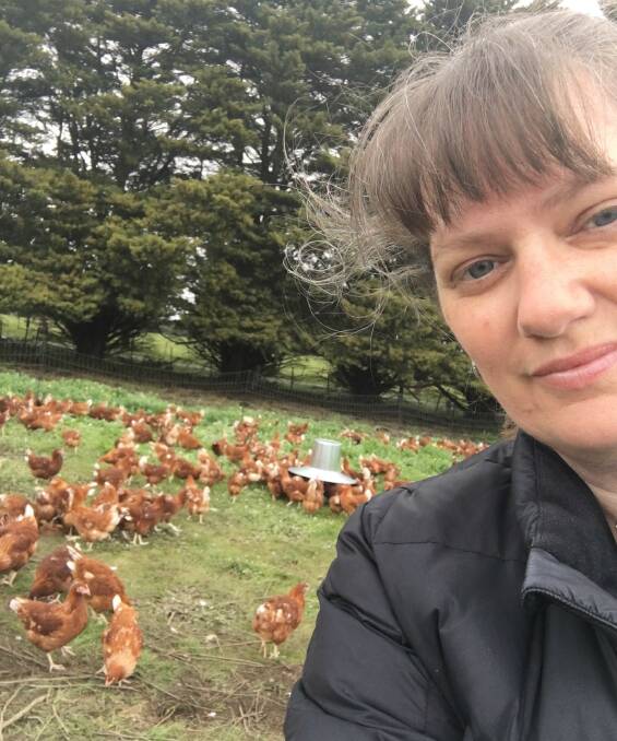 SELFIE CONTENT: Larissa Robins with her new hens settling into the farm life at Modewarre, near the Surf Coast, on Friday.