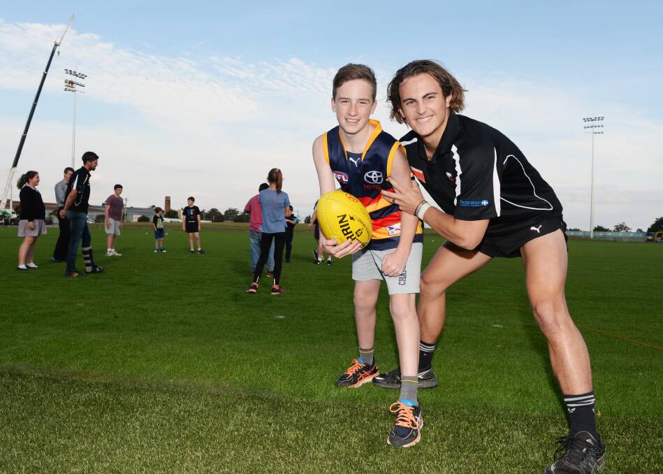 GAME ON: Twelve-year-old Connor gets ready for the Eureka Stadium re-opening with North Ballarat Rooster Ben Lusby. Picture: Kate Healy