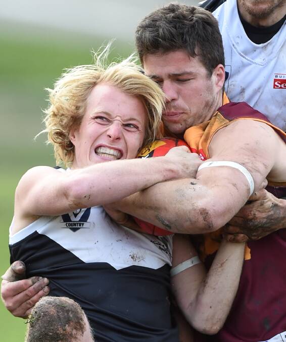 LOCK-UP: City youngster Sam Willian has plenty of bite but Lion Cal Currie outmuscles him in tough, contested play. This match was Willian's first major exposure to top opposition in BFL seniors. Picture: Lachlan Bence