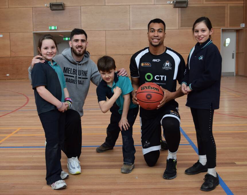 UNITED FORCE: Melbourne players Nate Tomlinson and Stephen Holt share tips with Yuille Park pupils Zoe Moylan, Jett Powell and Telia Johnson.