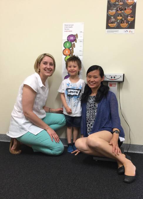 MEASURING UP: City of Ballarat maternal and child health nurse Sara Wignall and mother Fei Lian see how fast four-year-old Qiu Qiu is growing.