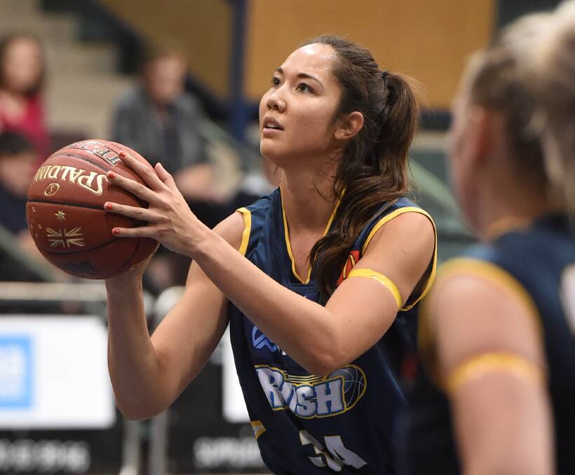 ROLE MODEL: Rush American import Joy Burke mentors young girls who look up to her as a basketballer, but the program is about life rather than just sport. Picture: Lachlan Bence