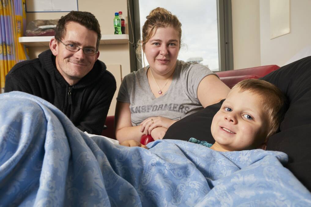 SMOOTH MOVE: Nic Baker and Jess Walsh look over son Leo as the children's ward relocates to make way for long-awaited upgrades. Picture: Luka Kauzlaric