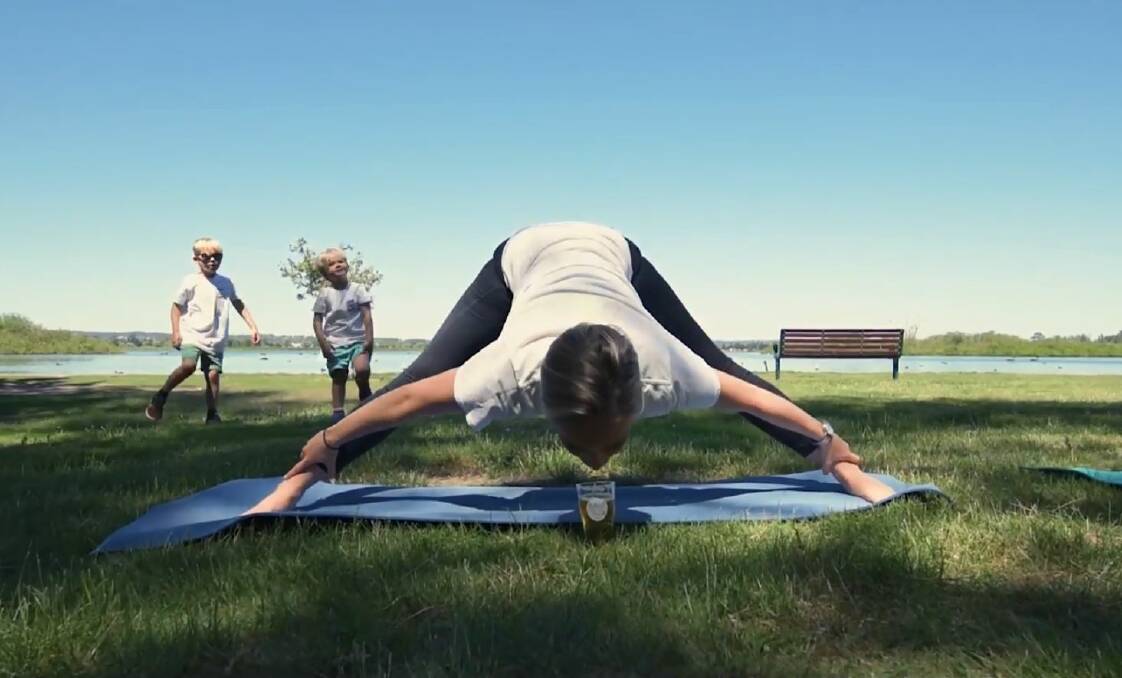 CALM: Bending for brew in a scene from The Healthy Hub Wellness Centre's beer yoga promotional video set by Lake Wendouree. Picture: @healthyhubballarat on Facebook