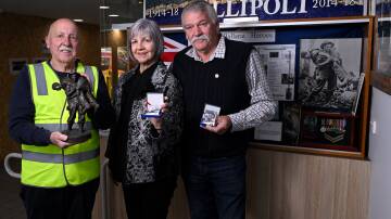 Ballarat RSL veterans advocate Phil Carter with Corporal Leslie "Bull" Allen's children Eleanor Johnson and Leslie Allen, holding the Anzac Appeal badges featuring their father. Picture by Adam Trafford