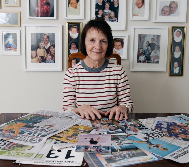 PROUD MUM: Kathy Tallent reminisces with newspaper clippings following Jared and Rachel's athletic careers.
