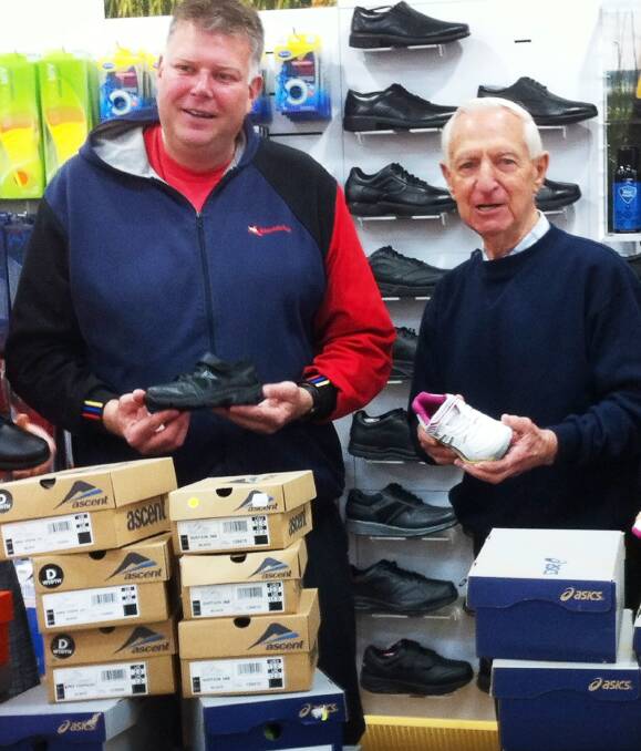 GIFT BOXES: The Athlete's Foot owner Paul Tudorovic presents shoes for the region's needy to 3BA Christmas Appeal director Peter Caligari to help kick-off the annual campaign. 