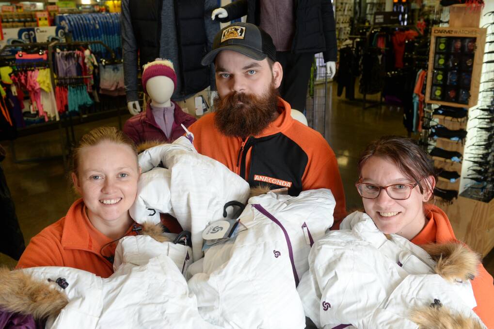 WARM APPROACH: Anaconda Ballarat's Kelsi Gull, Alex Clements-Tayler and Mel Wood prepare jackets to give to the homeless and needy this winter. Picture: Kate Healy