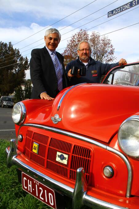 Professor George Kannourakis with Classic and Vintage Car Club Ballarat president Kevin Holloway having a cuppa by a Morris Minor convertible.
 