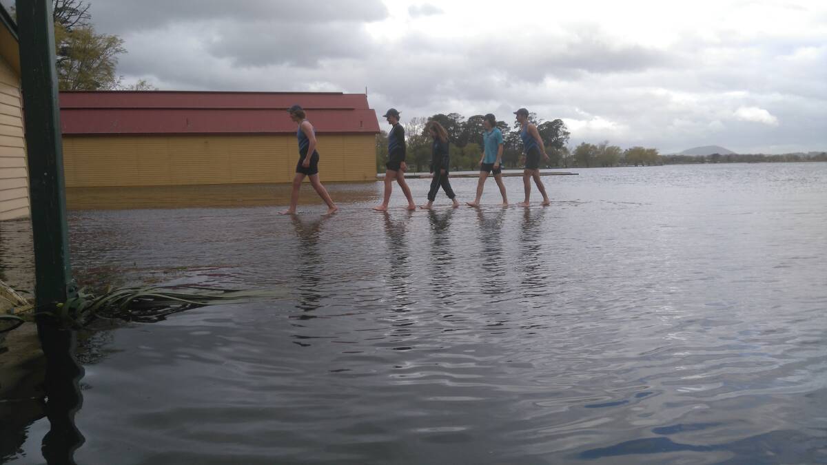 WATER WORK: A Ballarat High School senior boys crew walks on water in an attempt to train out of their sheds on Lake Wendouree earlier this week. 