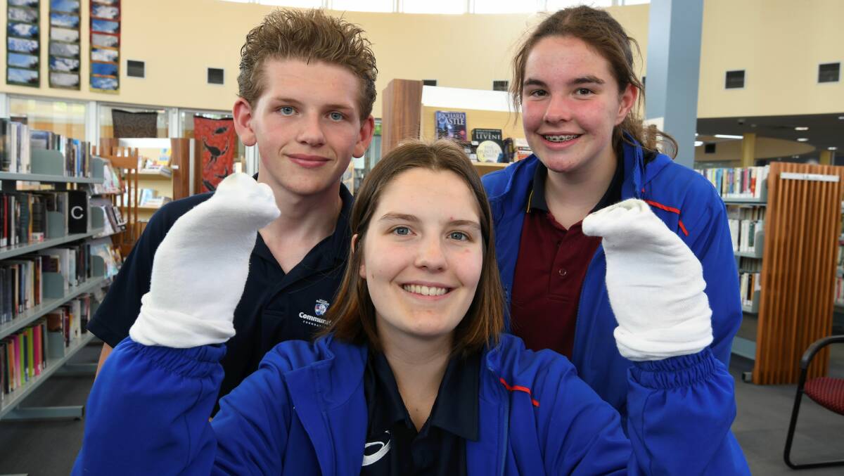 Riley Caldow, Hannah Farhall and Amy Zuell collected 1500 pairs of socks and developed care packages to be donated around Ballarat via the Soup and Shower Bus services. Picture: Lachlan Bence
