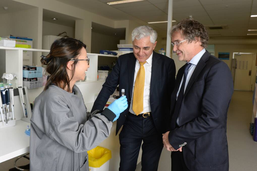 SHARING: FECRI director George Kannourakis and Professor Jan-Inge Henter talk with PhD student Marice Alcantara about her research. Picture: Kate Healy