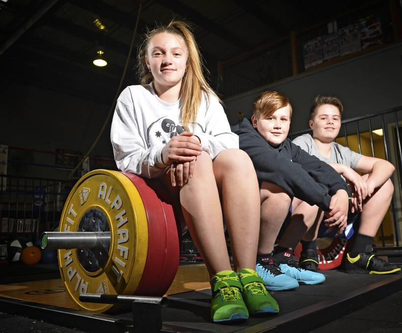 INSPIRED: Ashanti Barbera (14), Evan Clyne (13) and Liam Forde (12) styarted Olympic weightlifting to strengthen their other sporting pursuits. The Rio Games has shown them what is possible. Photo: Dylan Burns