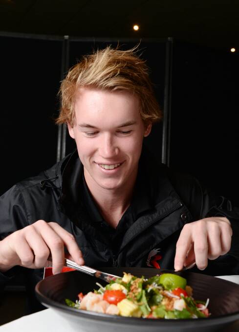 FUELLING UP: Rooster Ben Simpson enjoys a healthy Thai prawn vermicelli salad in his mid-week match preparation at North Ballarat Sports Club on Tuesday. Picture: Kate Healy