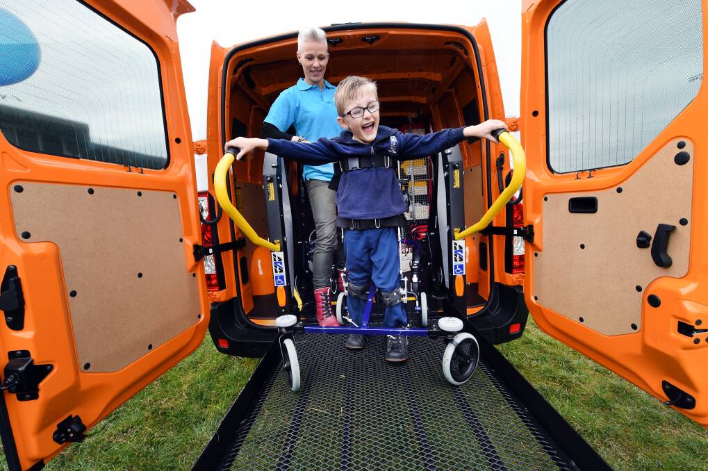 ALL SMILES: Archie Sims is the first to test out the new mobile specialist physiotherapy service for regional children at the Ballarat launch. Picture: Jeremy Bannister