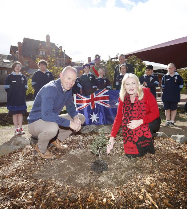 GROWING: Macarthur Street primary's Andrew Goodson and Wendouree MP Sharon Knight plant the Gallipoli Oak as student leaders look on. Picture: Luka Kauzlaric