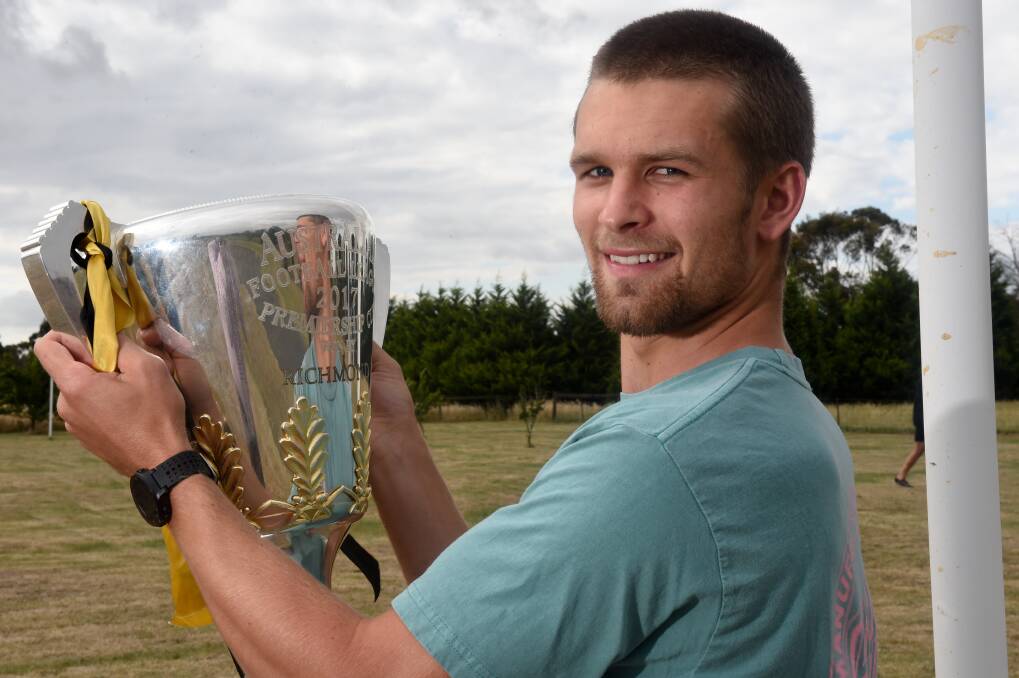 Exclusive look at Butler with the AFL premiership cup. Picture: Jeremy Bannister
