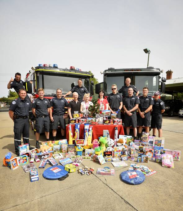 HEROES: Appeal director Peter Caligari, Uniting Ballarat's Naomi Bailey and Anglicare's Pauline Prebble with Ballarat City members and their toy efforts. There are about 90 career firefighters at Ballarat City and Lucas. Picture: Dylan Burns.