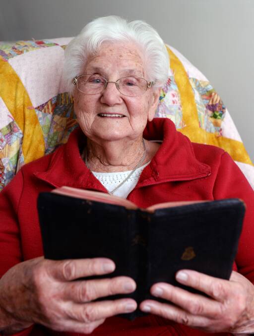 REUNITED: Betty Webber, 92, with her Salvation Army song book she had returned after it was missing for more than 40 years. Picture: Kate Healy.