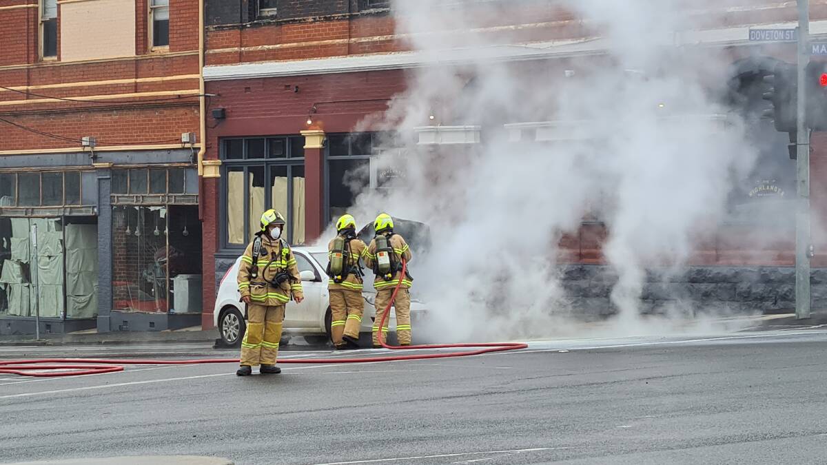 Firefighters extinguish the car fire on Mair Street. Pictures: The Courier