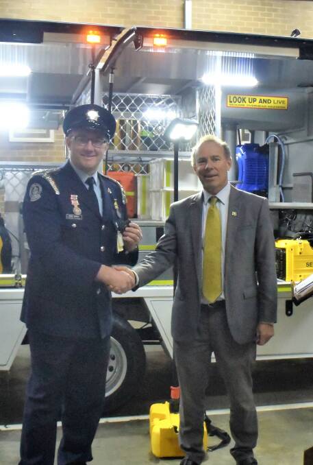 Handover: Sebastopol Fire Brigade Captain Ben Carey with Buninyong Geoff Howard at the handover of a new liquid petroleum gas specialist response vehicle, the first in the state to be fitted with new LPG burner technology. 