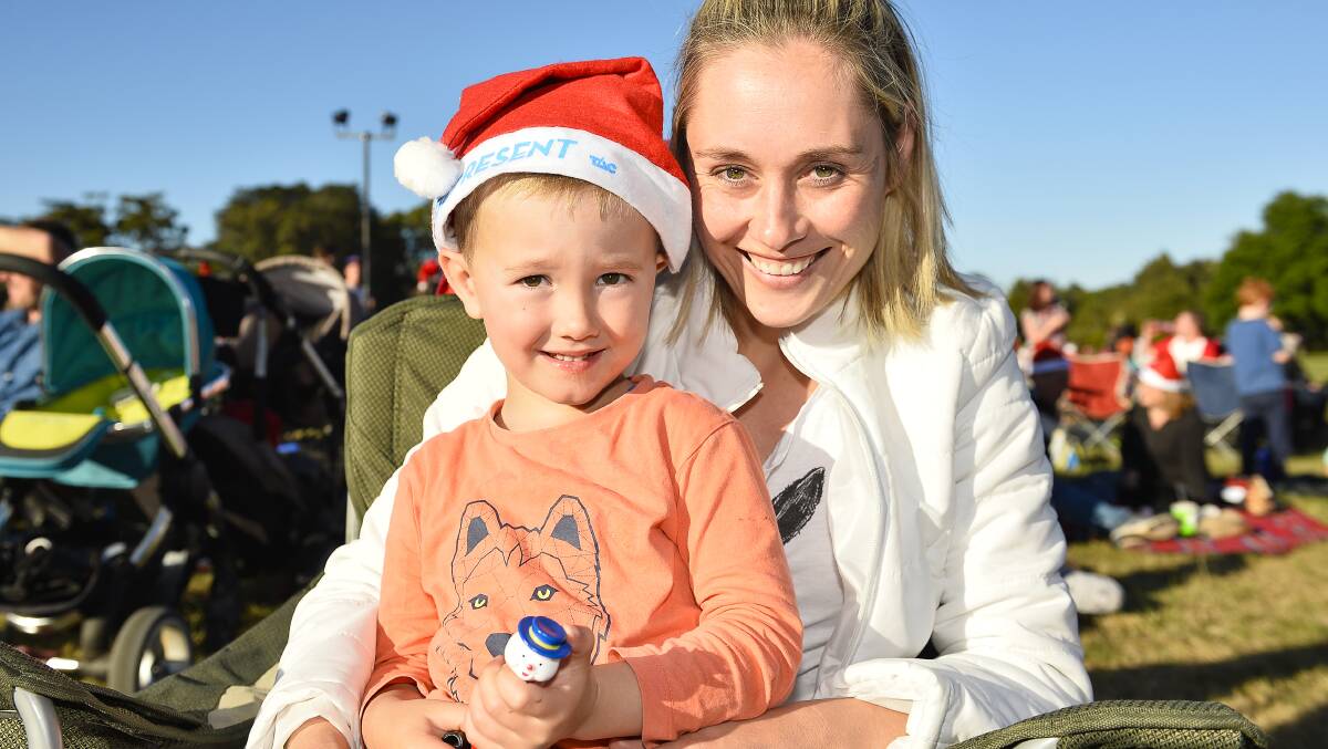 Cheer: Emma Nilsson and Zeb Nilsson, 4, at the 2016 Ballarat Christmas Carols by Candlelight at the North Gardens Reserve. Picture: Dylan Burns