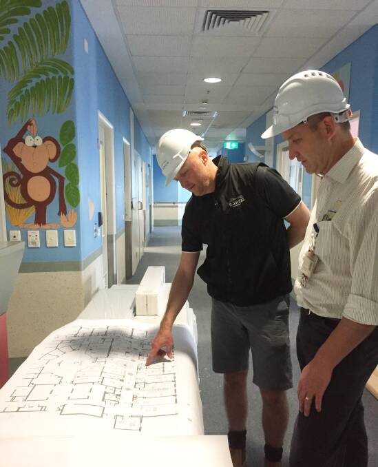 Blueprint: S.J. Weir Ballarat director Craig Jenkins and BHS nurse unit manager Clinton Griffiths with plans for the Base Hospital children's ward redevelopment. 