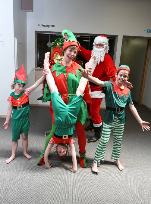 Joyous: Santa and his cheeky elves, five-year-old Lucy Walter, eight-year-old Phoebe Walter, Alisa Walter and 11-year-old Jona Tudball, are ready to make a special appearance at the Ballarat Carols. Picture: Lachlan Bence