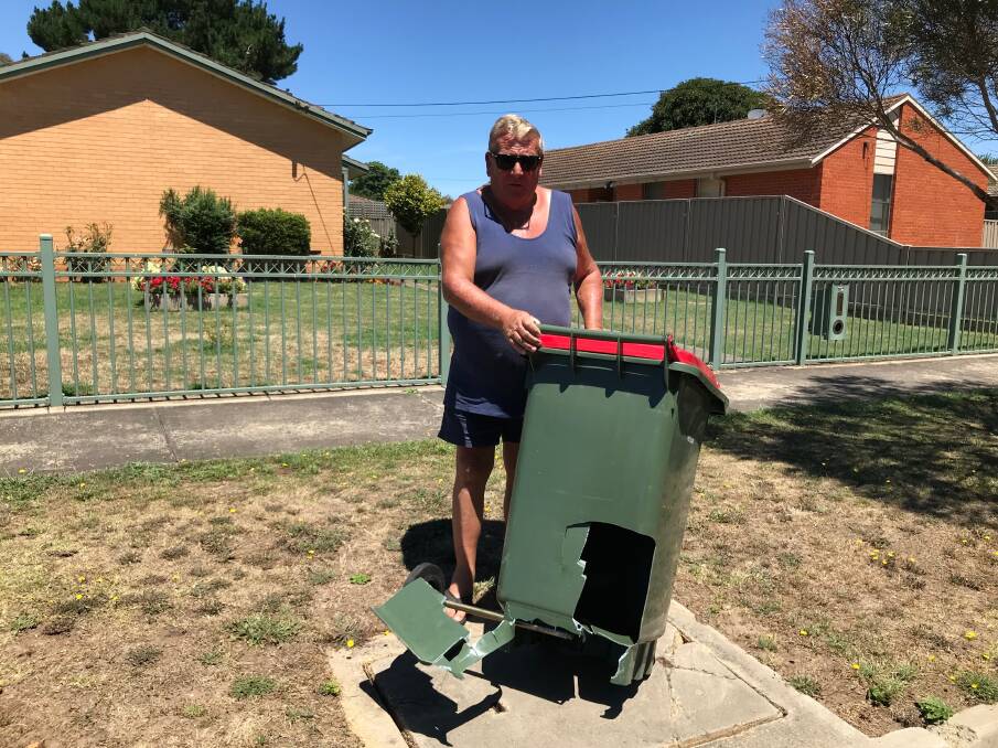Rubbish: Willow Grove resident Ray Blake with his garbage bin, which was broken during collection on Monday, after weeks of no collection in the street. 