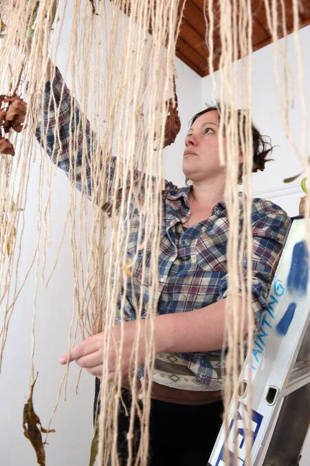 Immersive: Federation University visual communications student Sarah Caruana installs her mixed media piece 'Transcending Elements' for the Arts Academy End of Year Exhibition. Picture: Kate Healy