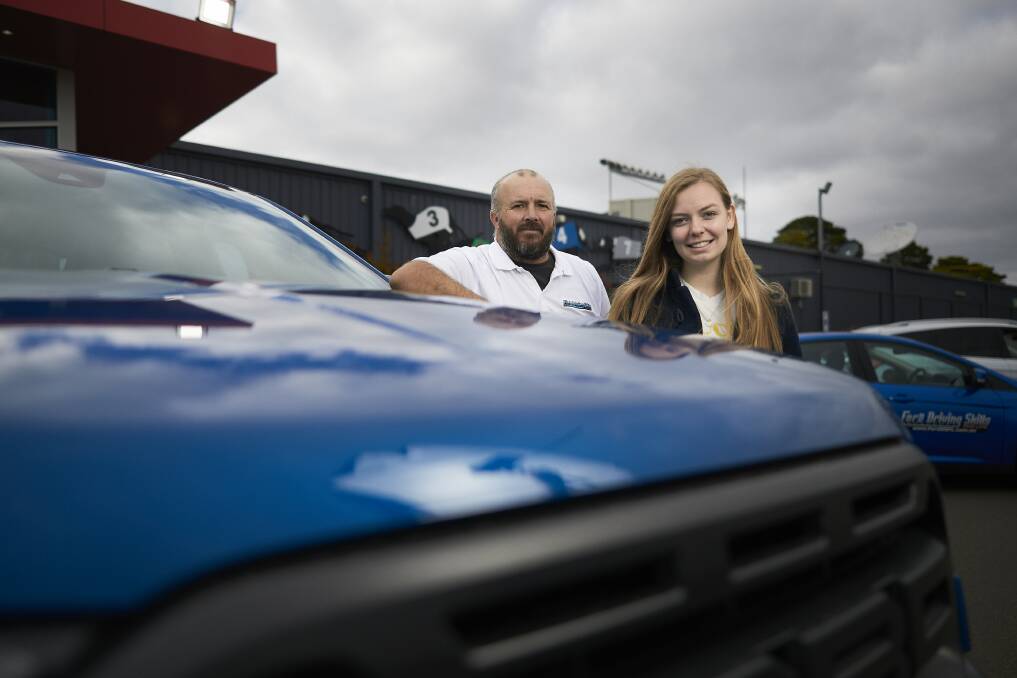 Right direction: Ford Driving Skills for Life program director James Stewart with participant Courtney Betts, 17, at the Ballarat Greyhound Racing Track on Sunday. Picture: Luka Kauzlaric