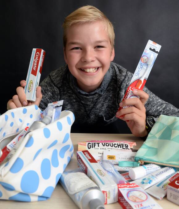 BENEFACTOR: James Dawes, 11, with a selection of toiletries and other goodies in his Hampers for the Homeless. Picture: Kate Healy