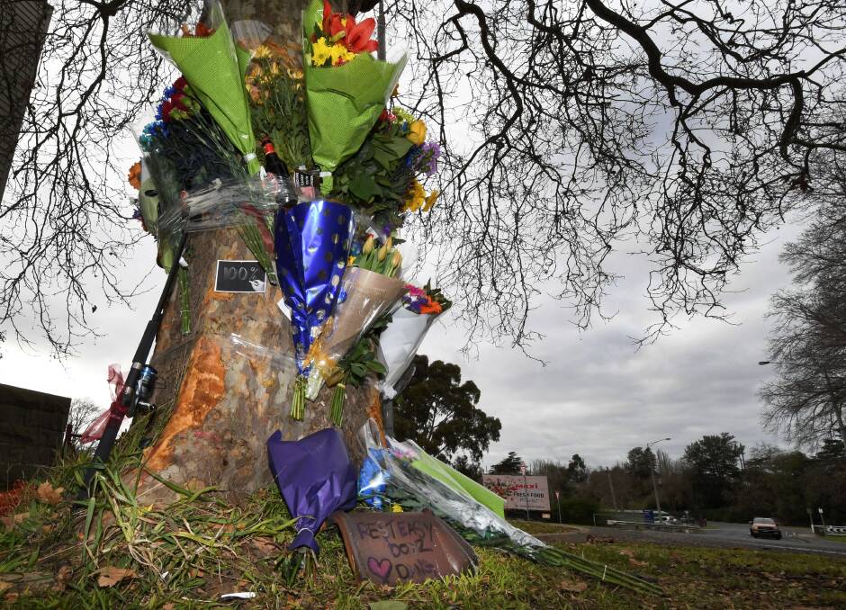 TRIBUTES: Flowers, photos and messages have been left at the tree in Nolan Street, the scene of Friday morning's fatal crash. Picture: Lachlan Bence