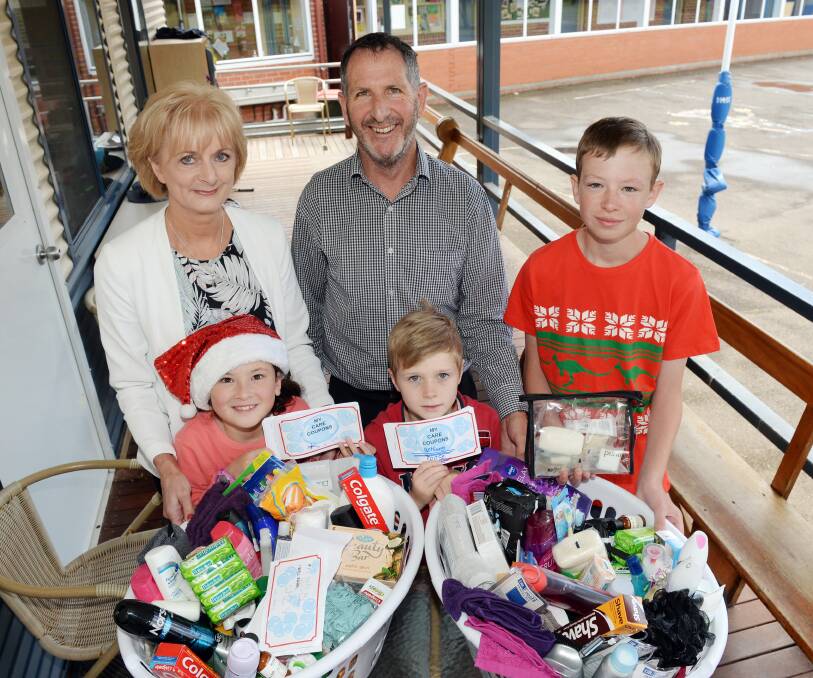 GENEROUS: Lou Gnoato, Lyna Begbie (grade 2), Steve Kennedy, Paddy McKay (grade 2) and Campbell Leonard (grade 6, school captain) with the donations. Picture: Kate Healy