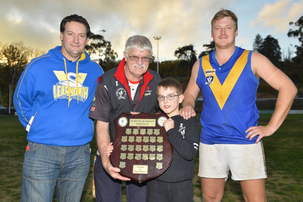 HONOURING: Sharon Siermans' father John and son Aron pose with the shield with Learmonth's coach Steve Biggin, left, and captain Todd Curran. Picture: Dylan Burns