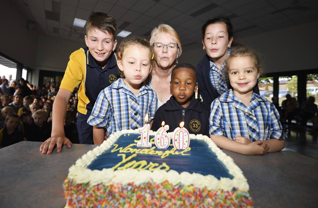 CELEBRATIONS: Birthday cake for Dana Street Primary's 160 years. Alexanda, Vicki Dunn, Luca, Eve, Sam and Savannah blow out the candles. Picture: Dylan Burns