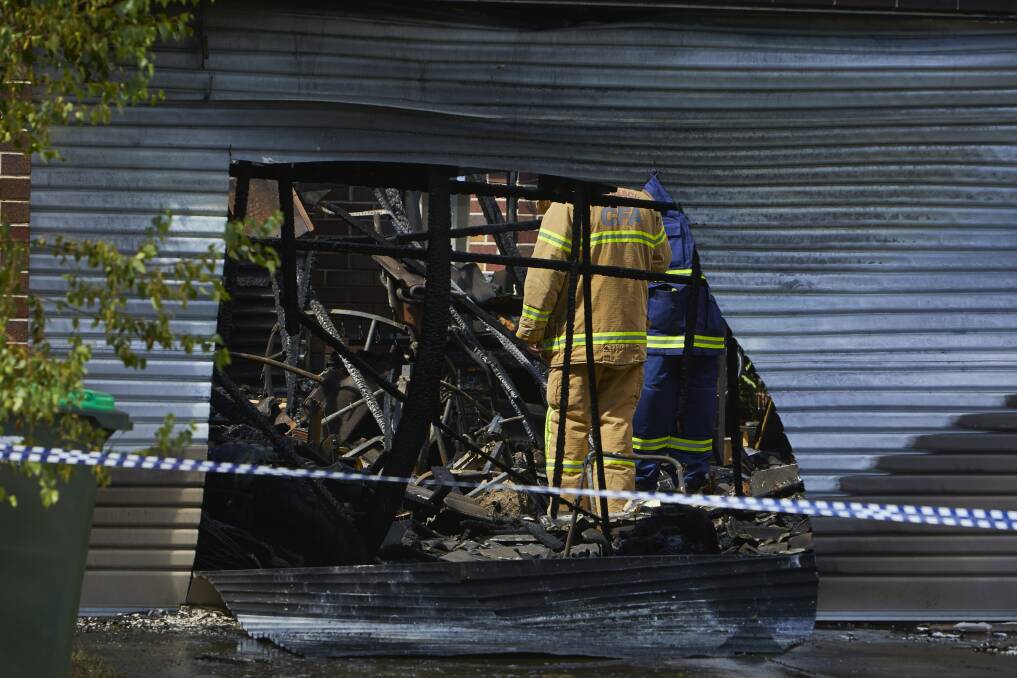 GONE: A fireman looks through the rubble of the Huntly's family home in Alfredton. Picture: Luka Kauzlaric