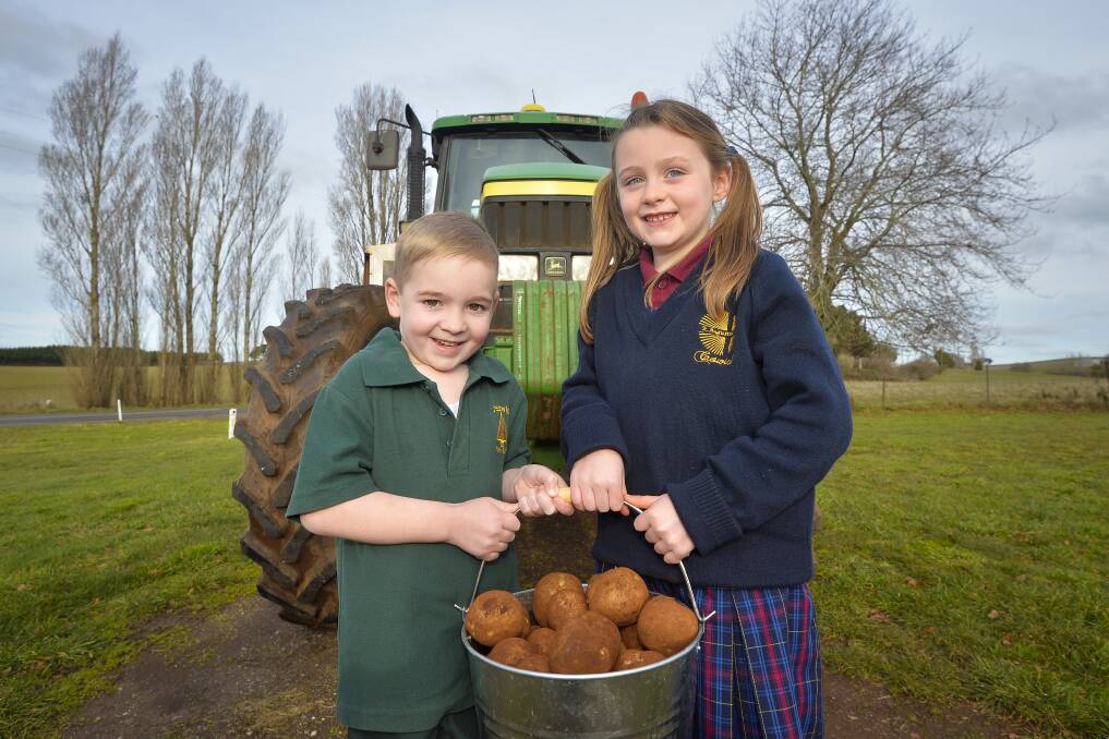 TASTY TREATS: Archie Quick, 5, and Alexa Novak, 7, prepare for the big spud dinner to raise funds for the Dean Hall. Picture: Dylan Burns
