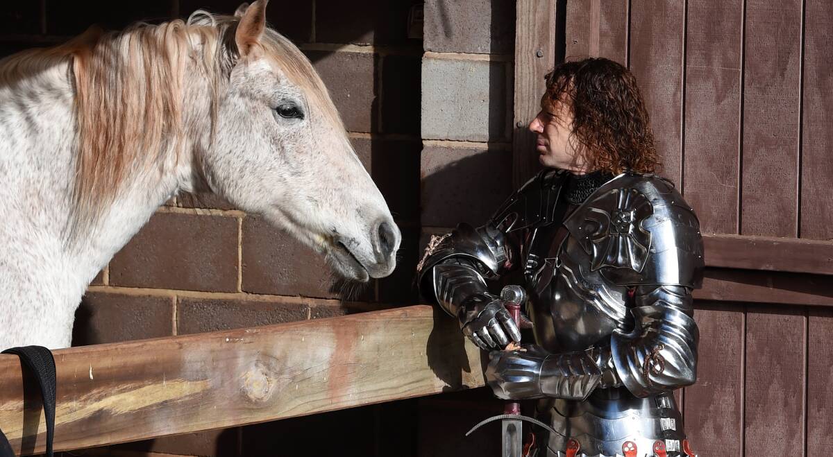 A KNIGHT'S TALE: Kryal Castle knight and arena manager Phillip Leitch with one of the horses from the popular tourist attraction.