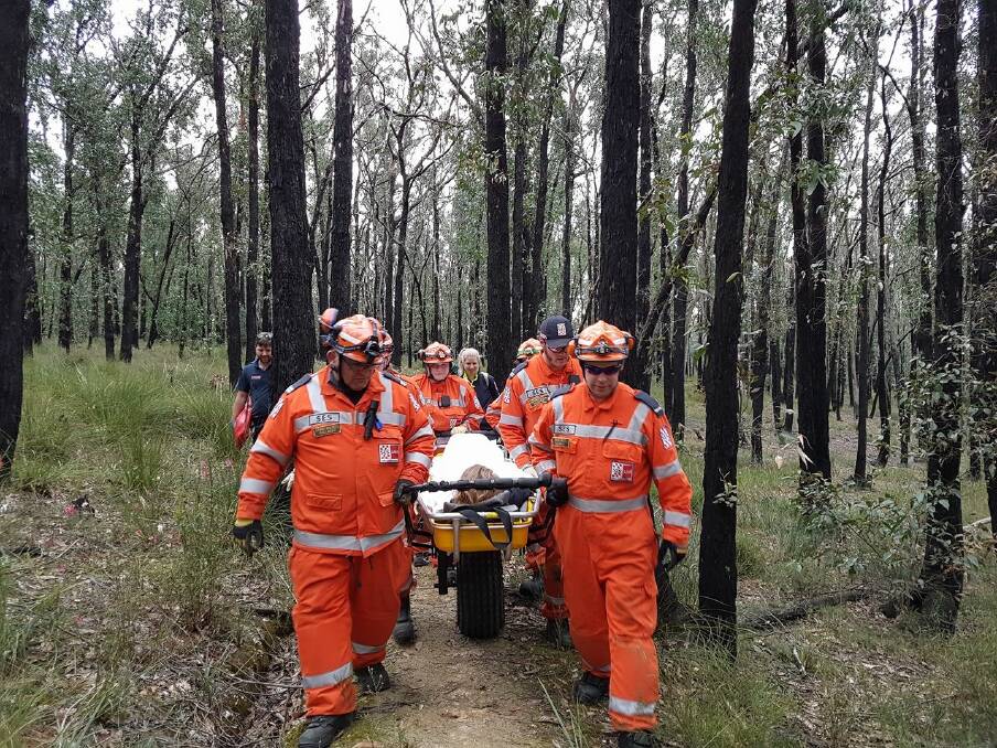 Helping hand: SES volunteers use their new mule stretcher carrier to assist a motorbike rider, who was injured while riding in the state forest near Scarsdale on Saturday afternoon. Picture: Supplied